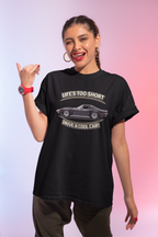 Woman wearing a black t-shirt with a vintage vette graphic and text against a gradient background