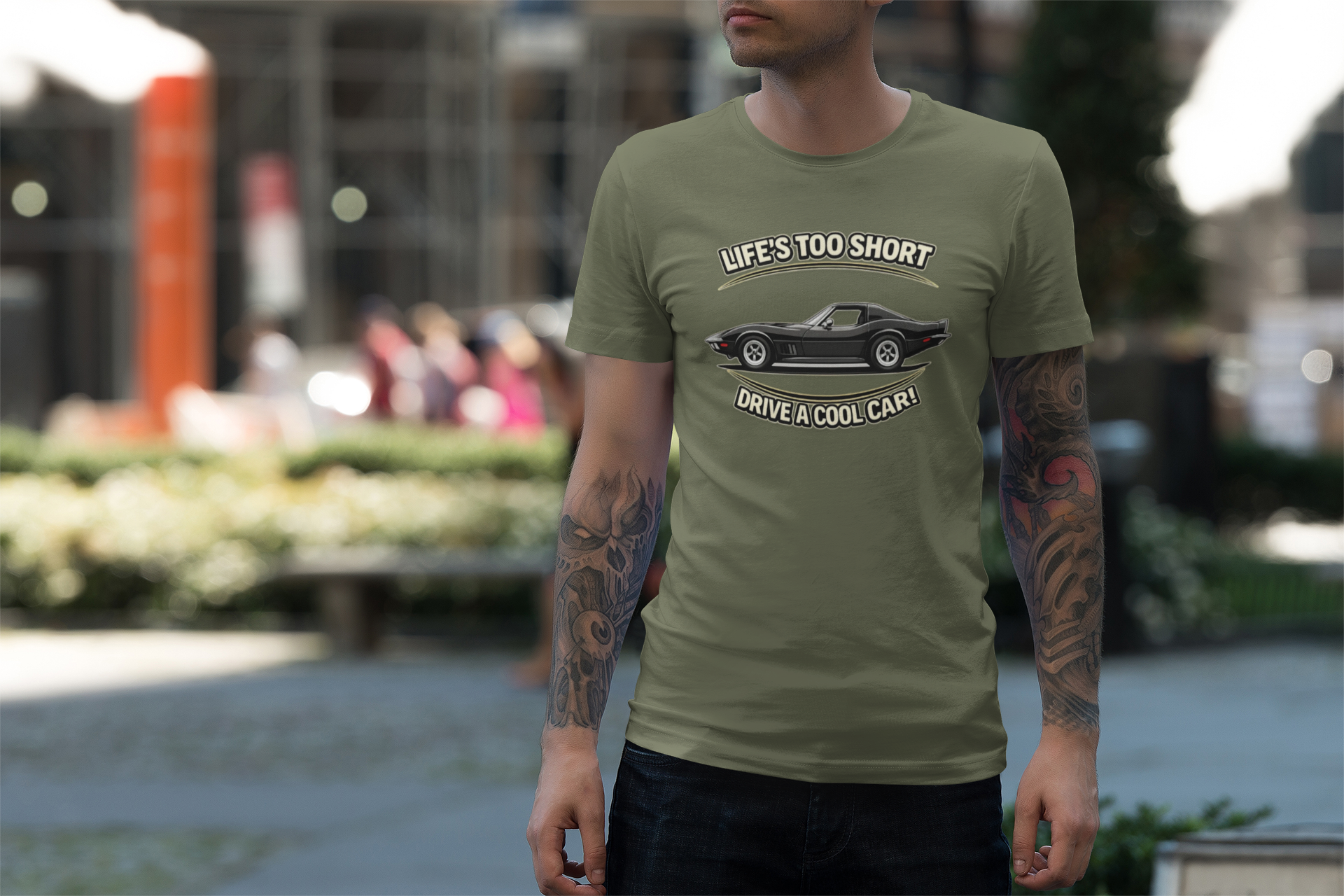 Man wearing a military green t-shirt with a vintage vette graphic and text in an outdoor setting