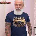 Man wearing a navy blue t-shirt with a classic car graphic design and text, standing against a light pink background.