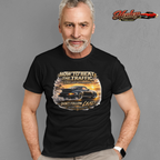 Man wearing a black t-shirt with a classic car graphic design and text, standing against a gray background with 'Healey Threads' branding.