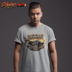 Man wearing a gray t-shirt with a classic car  graphic design and text, standing against a dark background.