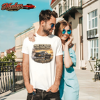Man wearing a t-shirt with a classic car graphic design and woman standing next to him on a sunny street.