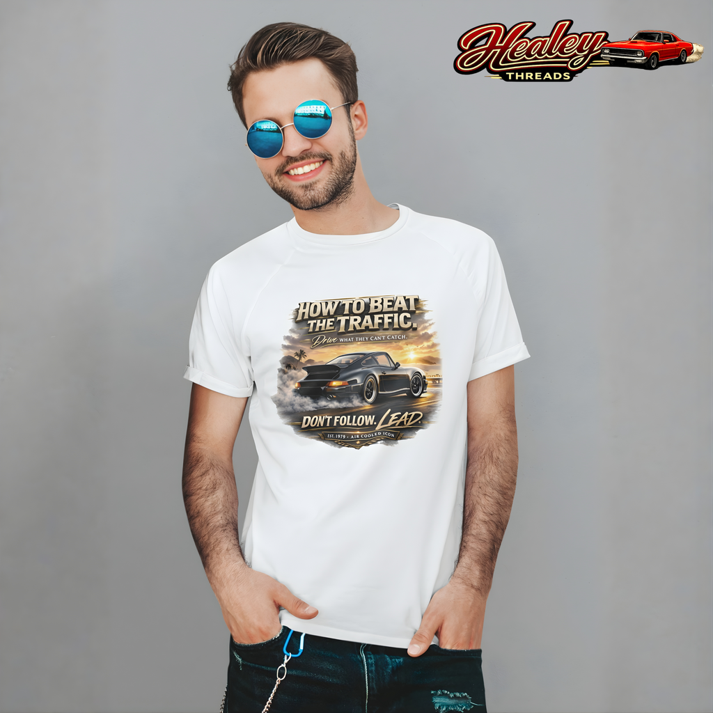 Man wearing a white t-shirt with a classic car graphic design and sunglasses, Healey Threads logo in the corner.