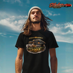 Man wearing a black t-shirt with a classic car graphic and text against a blue sky.