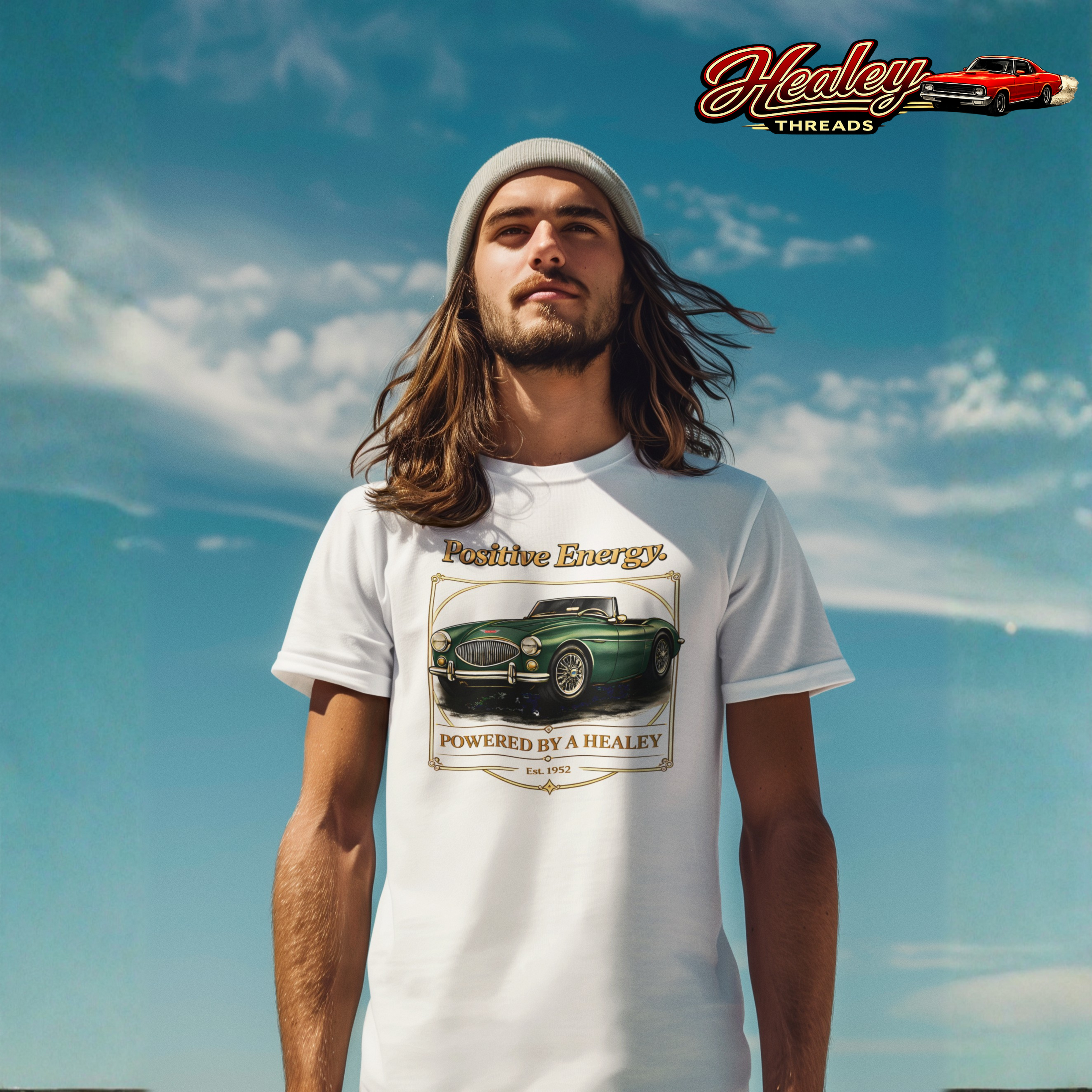 Man wearing a white t-shirt with a classic car graphic and 'Healey Threads' logo in the background.