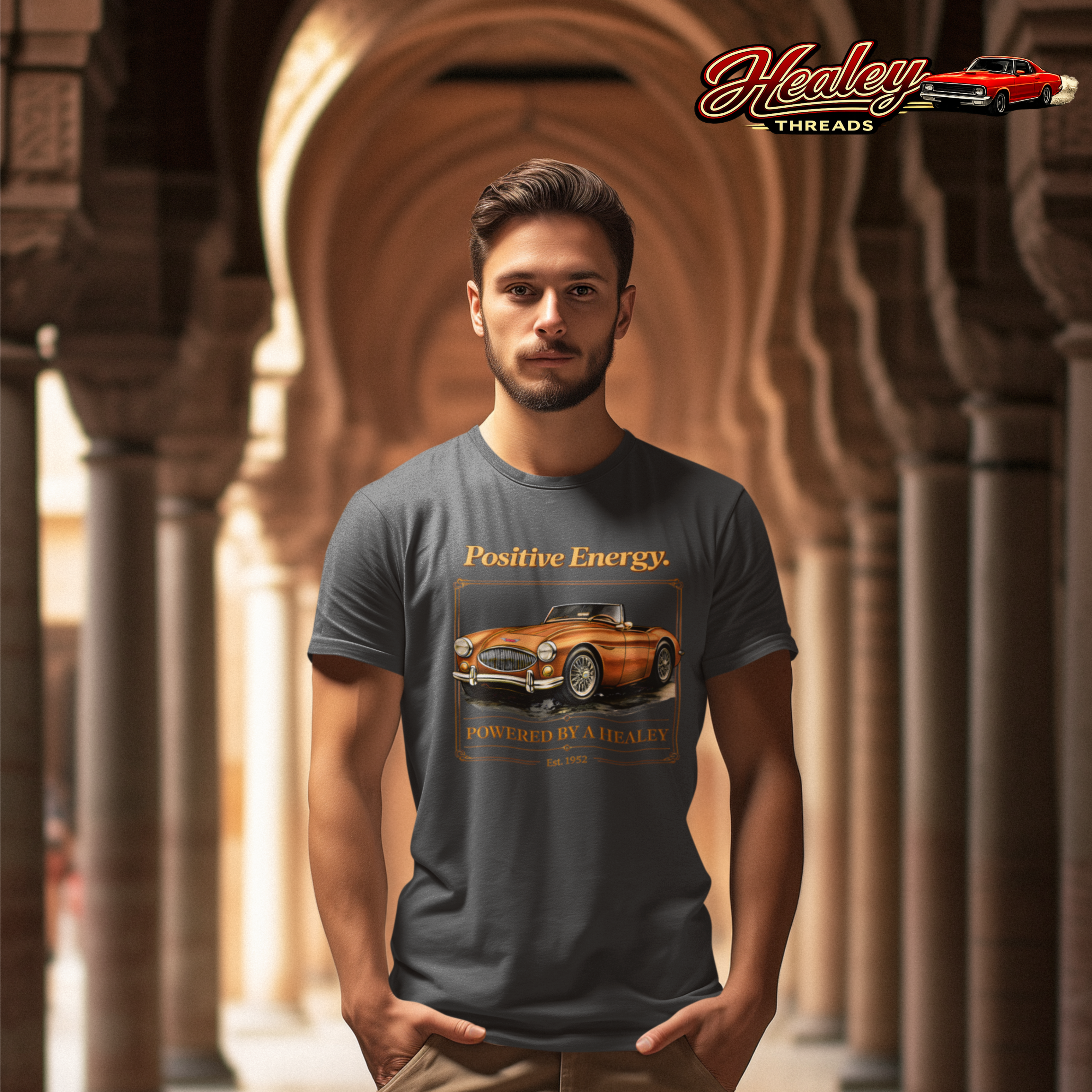 Man wearing a gray t-shirt with a vintage car graphic and 'Healey Threads' branding.