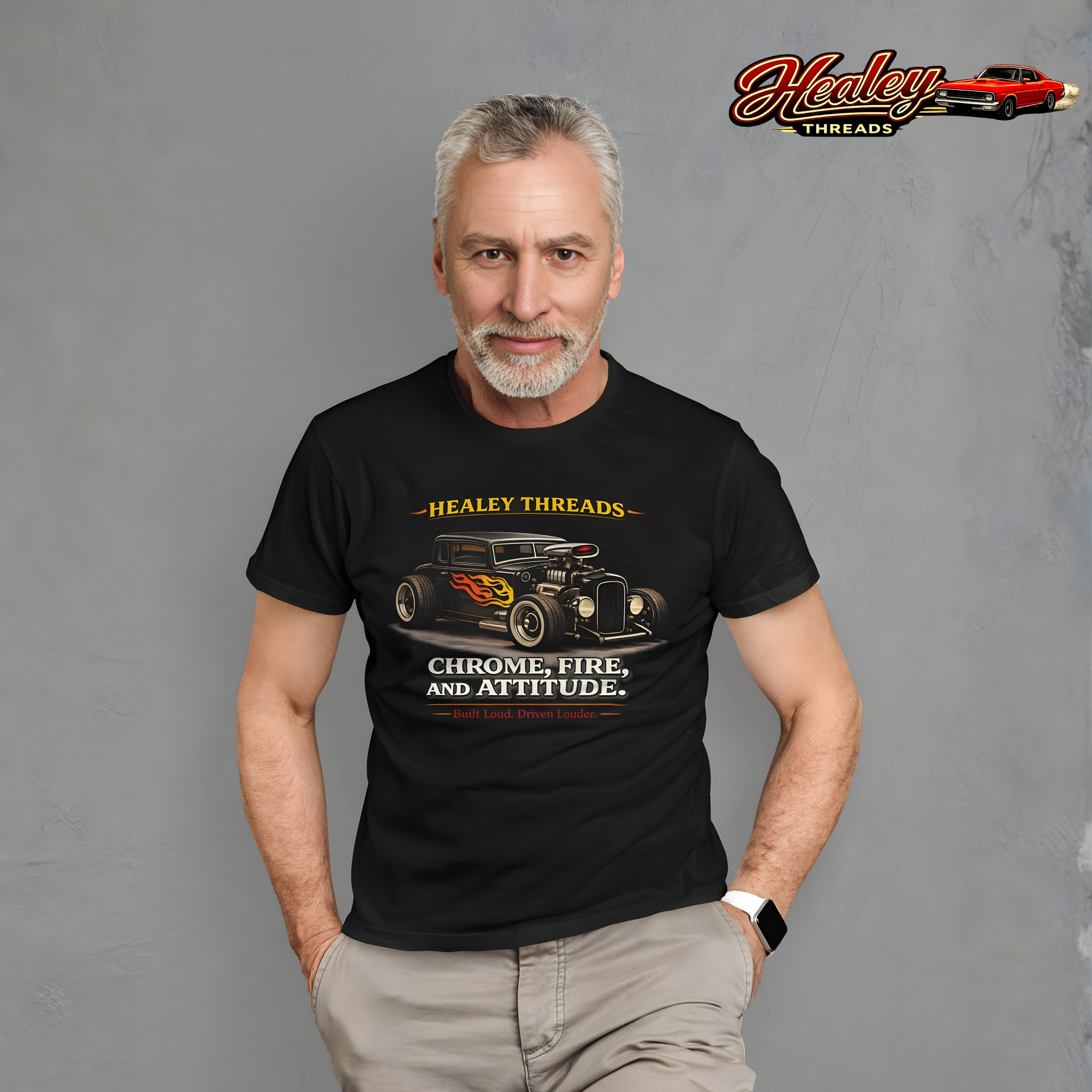 Man wearing a black t-shirt with a hot rod car graphic design on a gray background.