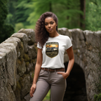 Woman wearing a white t-shirt with a graphic car design in a forest setting