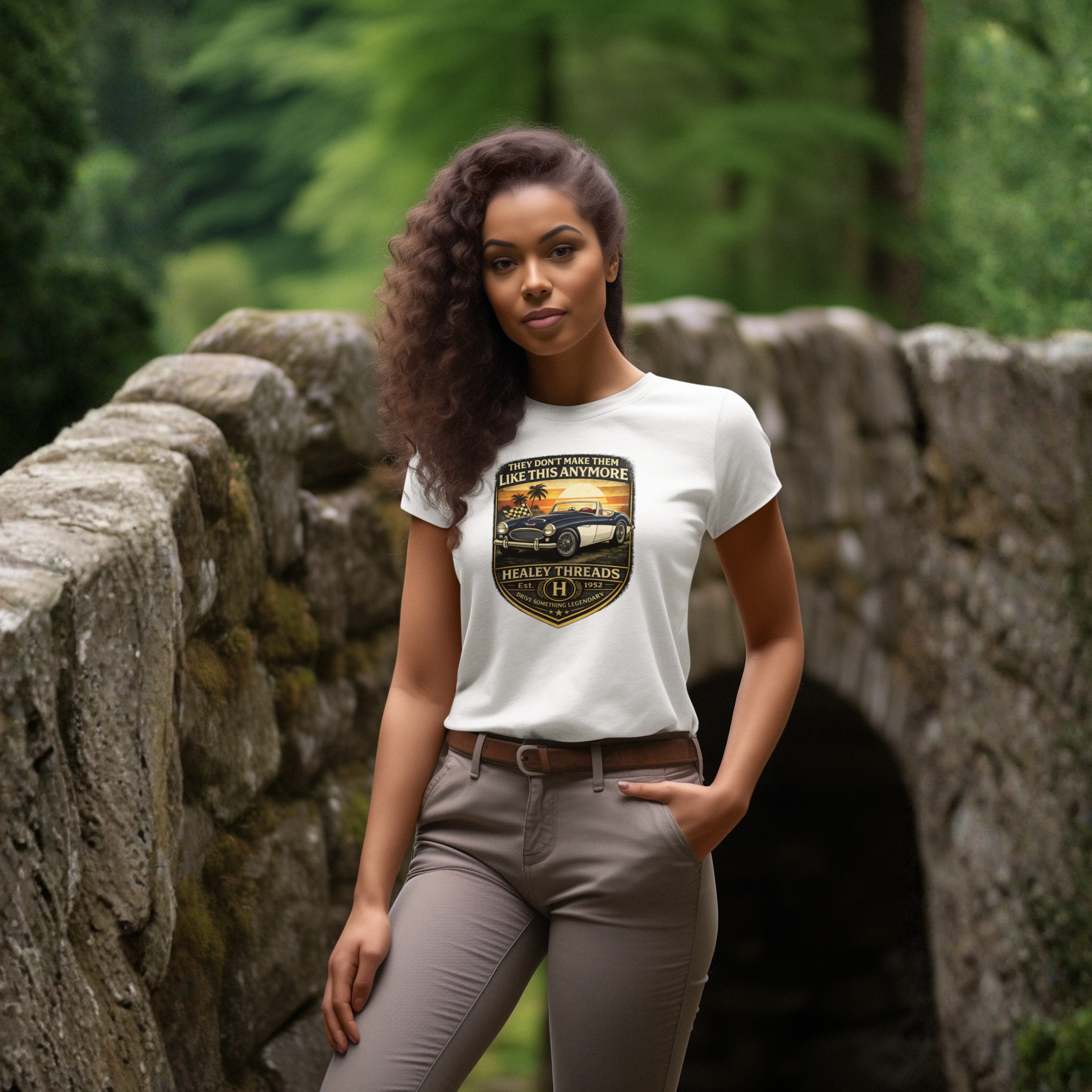 Woman wearing a white t-shirt with a graphic car design in a forest setting