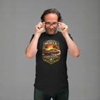 Man wearing a black t-shirt with a classic car graphic design on a gray background 