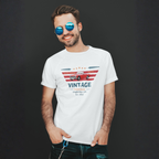 Man wearing a white t-shirt with a vintage car design on a dark background