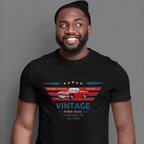 Man wearing a black t-shirt with a vintage car design on a gray background