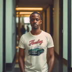 Man wearing a t-shirt with a classic car design and 'Healey' text in a hallway.