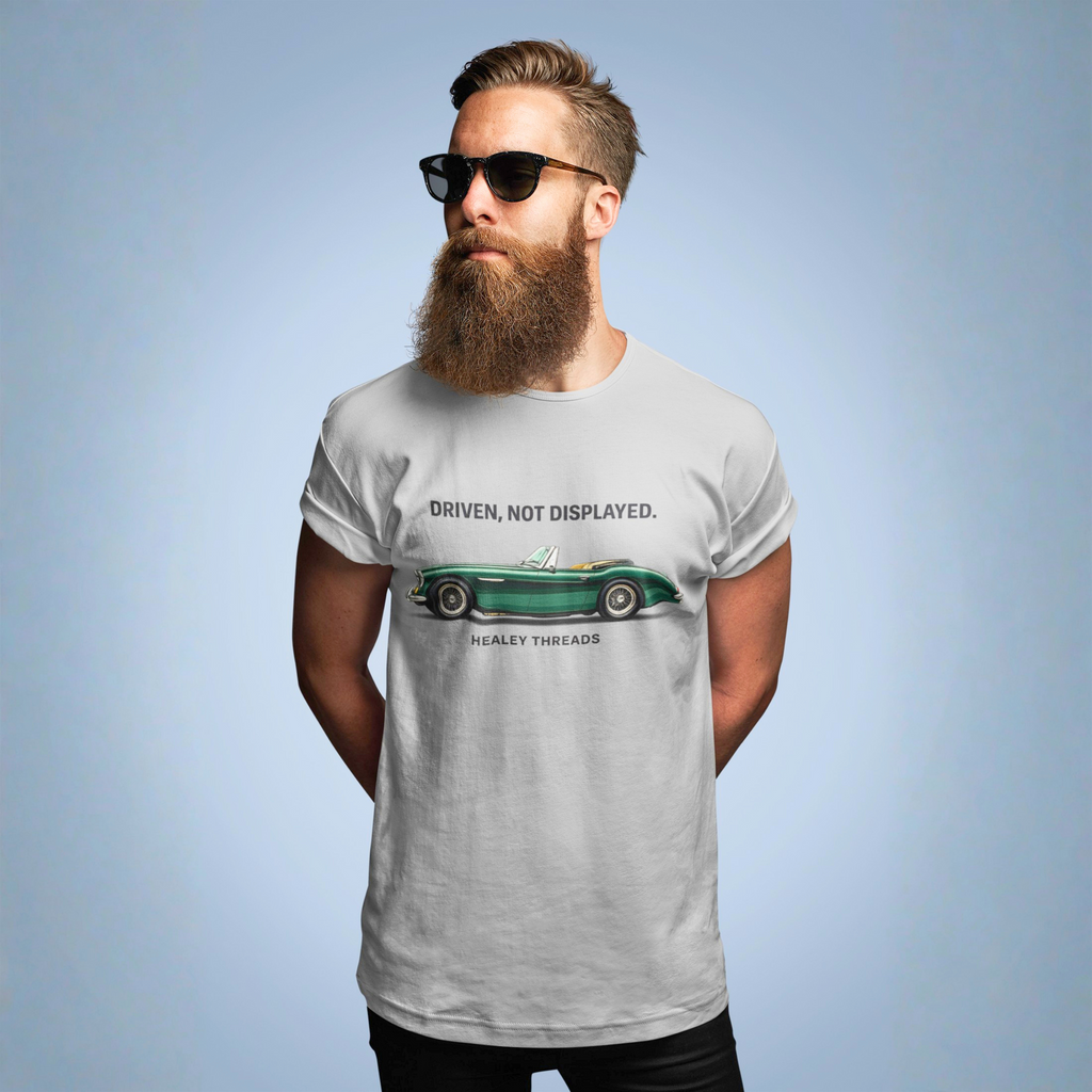 Man wearing a sport gray t-shirt with a vintage car design and text on a light blue background