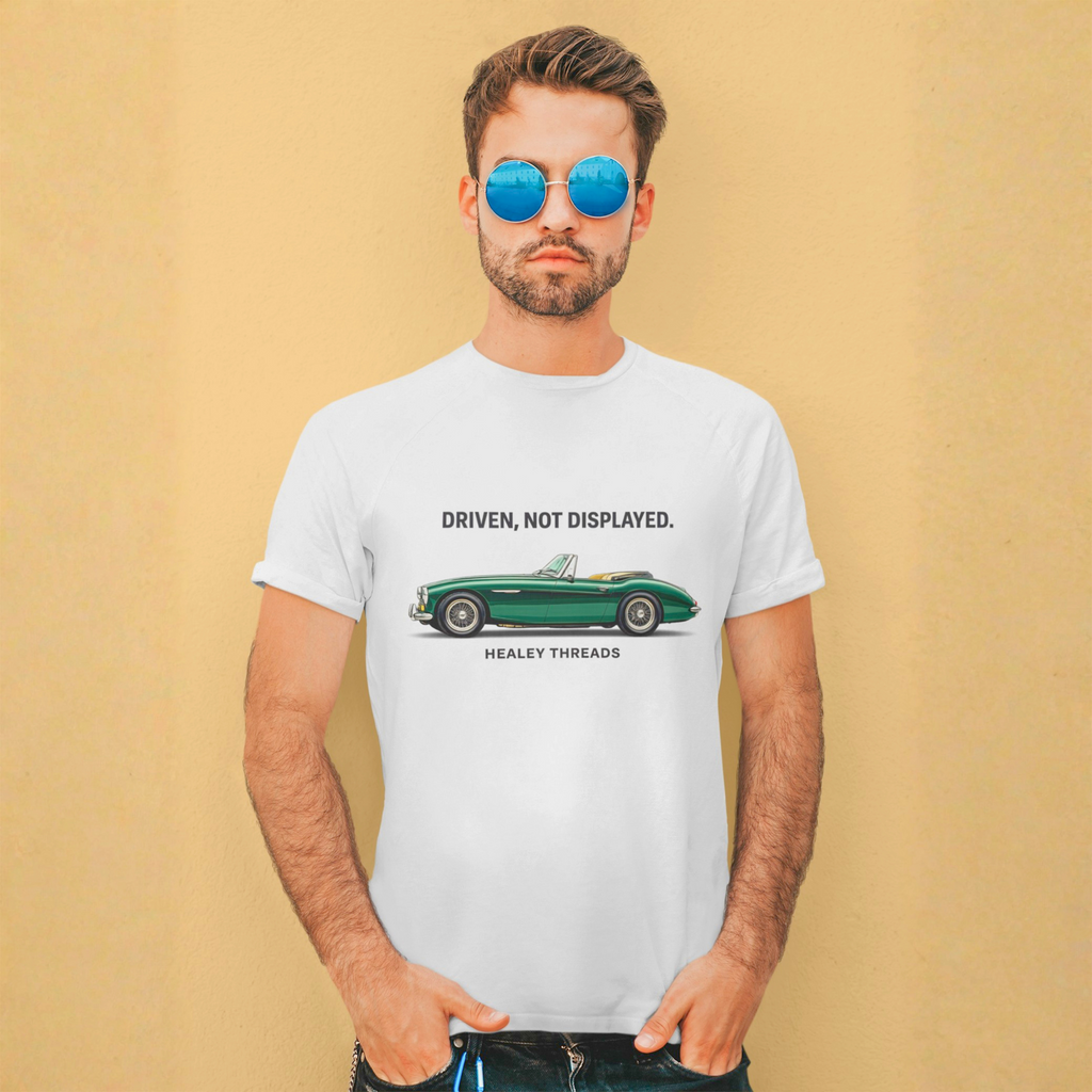 Man wearing a white t-shirt with a green classic car graphic and text against a beige background