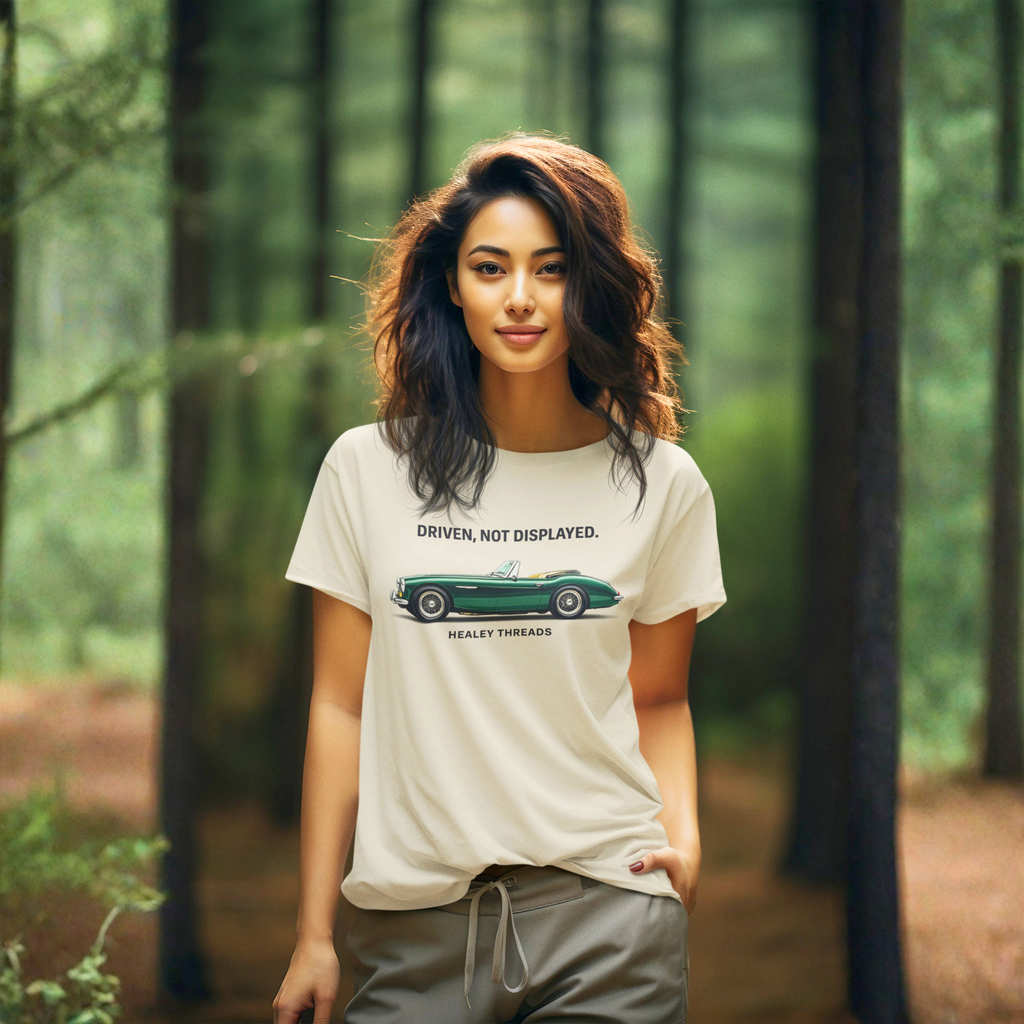 Woman wearing a white t-shirt with a classic car graphic design in a forest setting