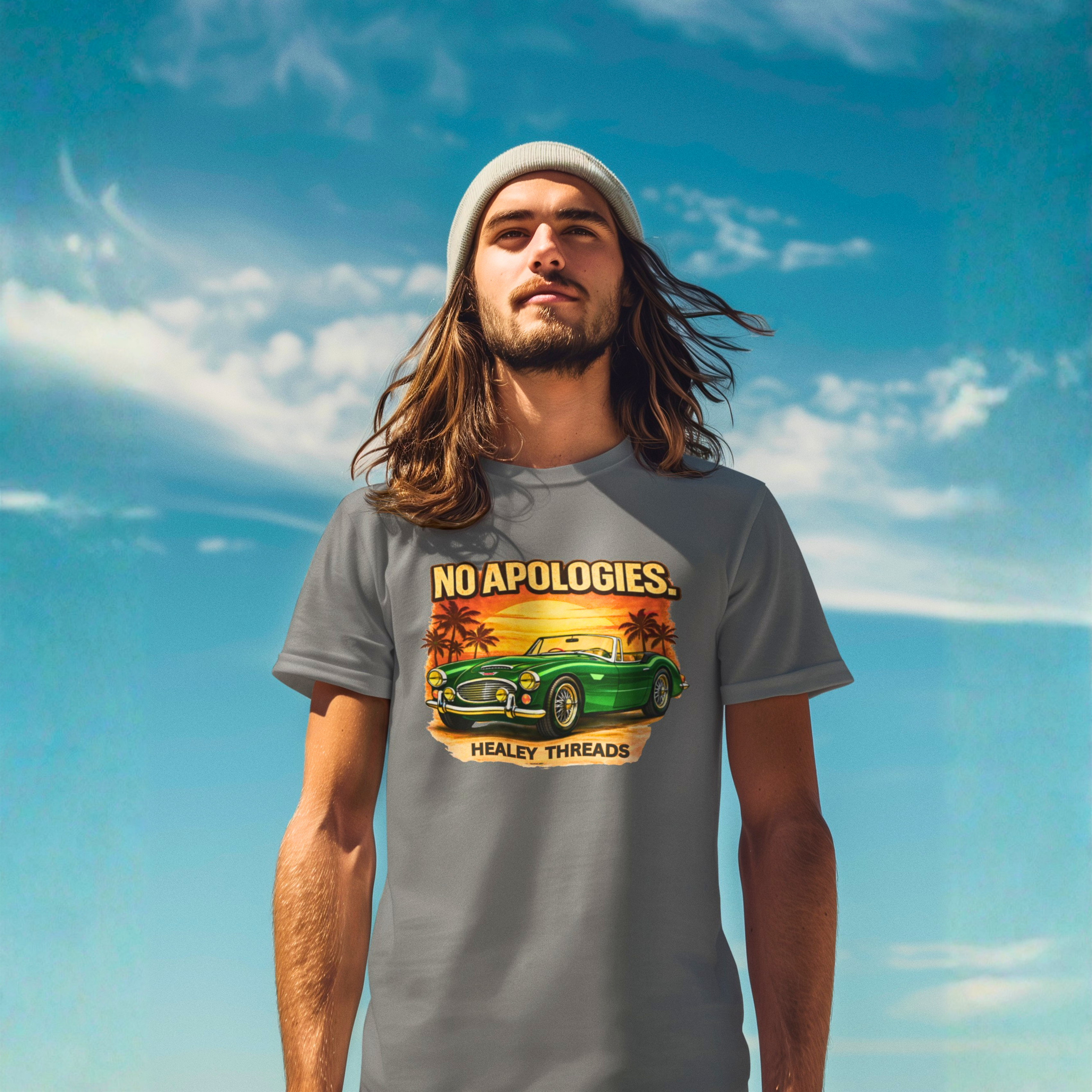 Man wearing a gray t-shirt with a graphic Healey car design against a blue sky