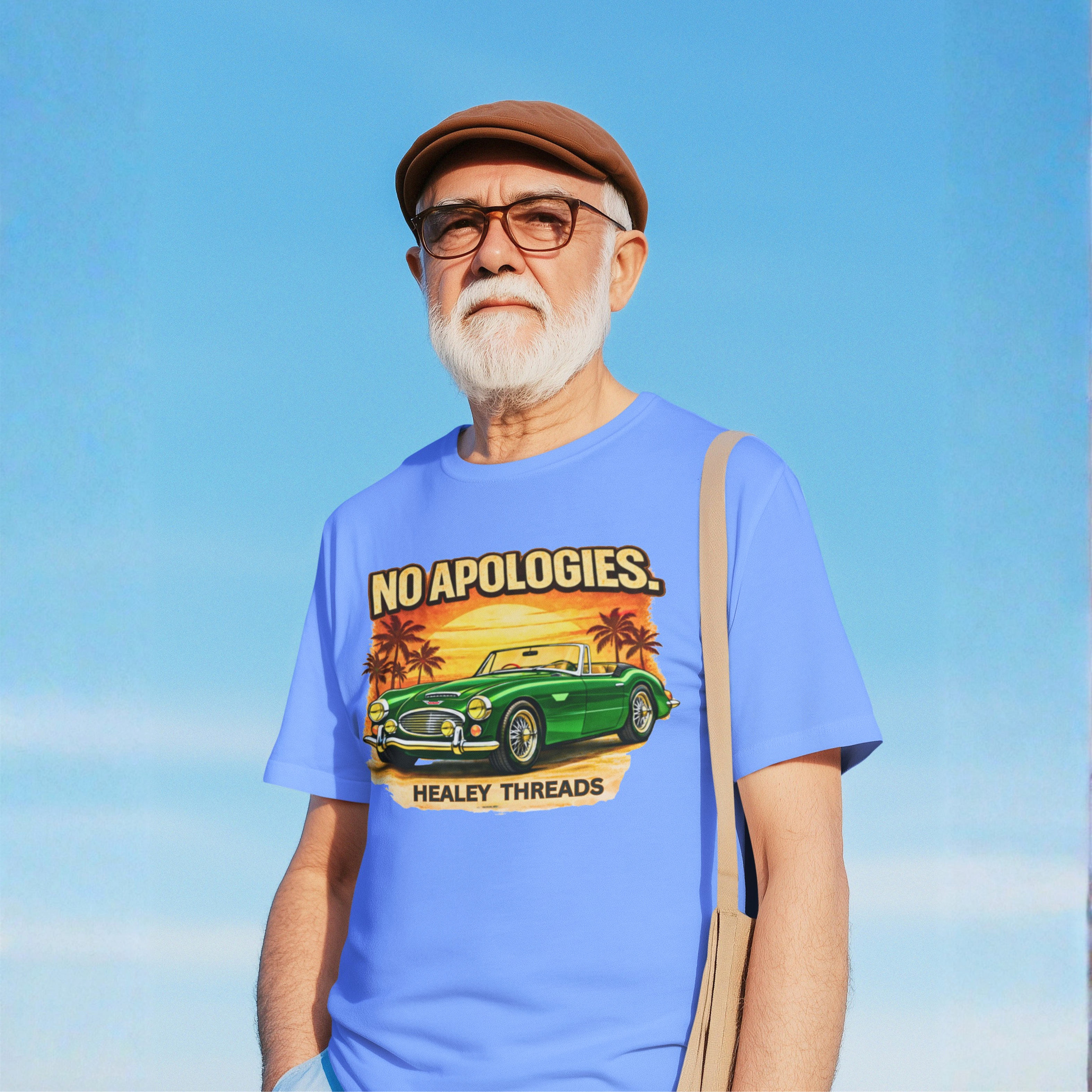 Man wearing a blue t-shirt with a graphic Healey car design against a clear blue sky