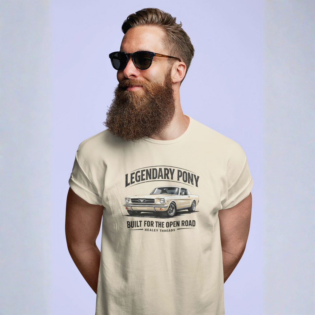 Man wearing a natural t-shirt with a classic car graphic and text, standing against a light blue background