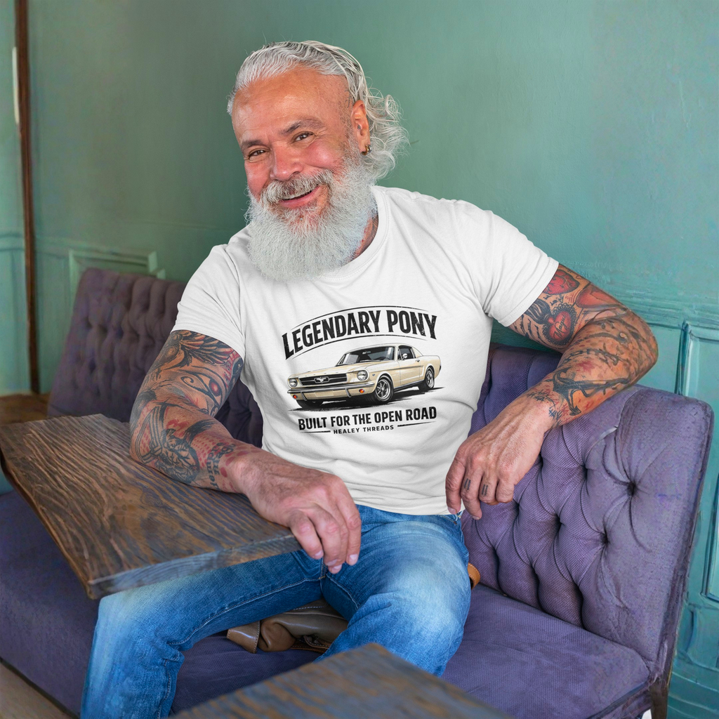 Man sitting on a purple couch wearing a white t-shirt with 'Legendary Pony' classic car graphic.