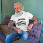 Man sitting on a purple couch wearing a white t-shirt with 'Legendary Pony' classic car graphic.