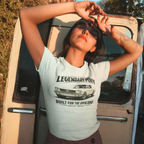 Woman wearing a white t-shirt with a classic car graphic and text, standing next to an open van door.