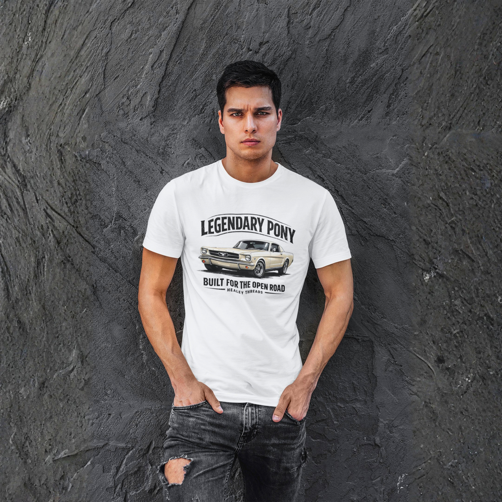 Man wearing a white t-shirt with a classic car graphic and text against a textured gray wall.