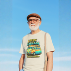Man wearing a natural t-shirt with 'Livin' the Dream' van design against a blue sky.