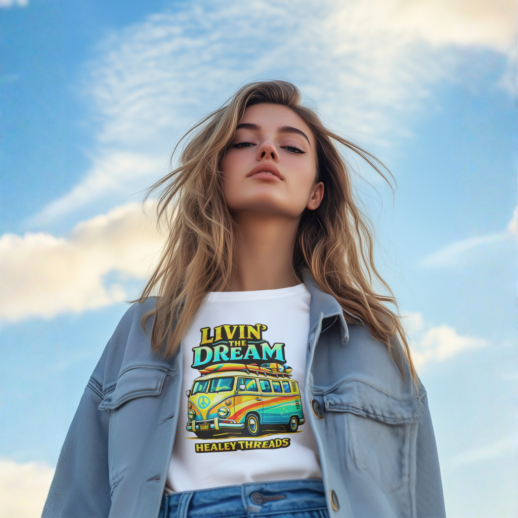 Woman wearing a white  t-shirt with a van graphic and text against a blue sky.