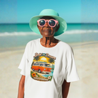 Woman wearing a white t-shirt with a graphic van design on a beach