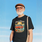 Man wearing a black t-shirt with a graphic van design against a blue sky.