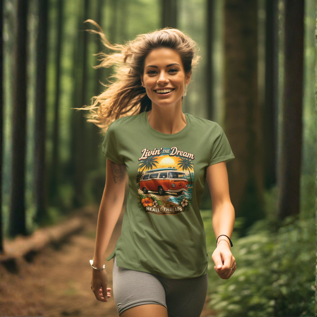 Woman wearing a military green t-shirt with a graphic design of a van and text, running through a forest.