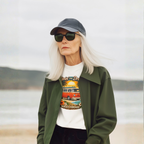 Woman wearing a graphic white t-shirt with a van design on a beach