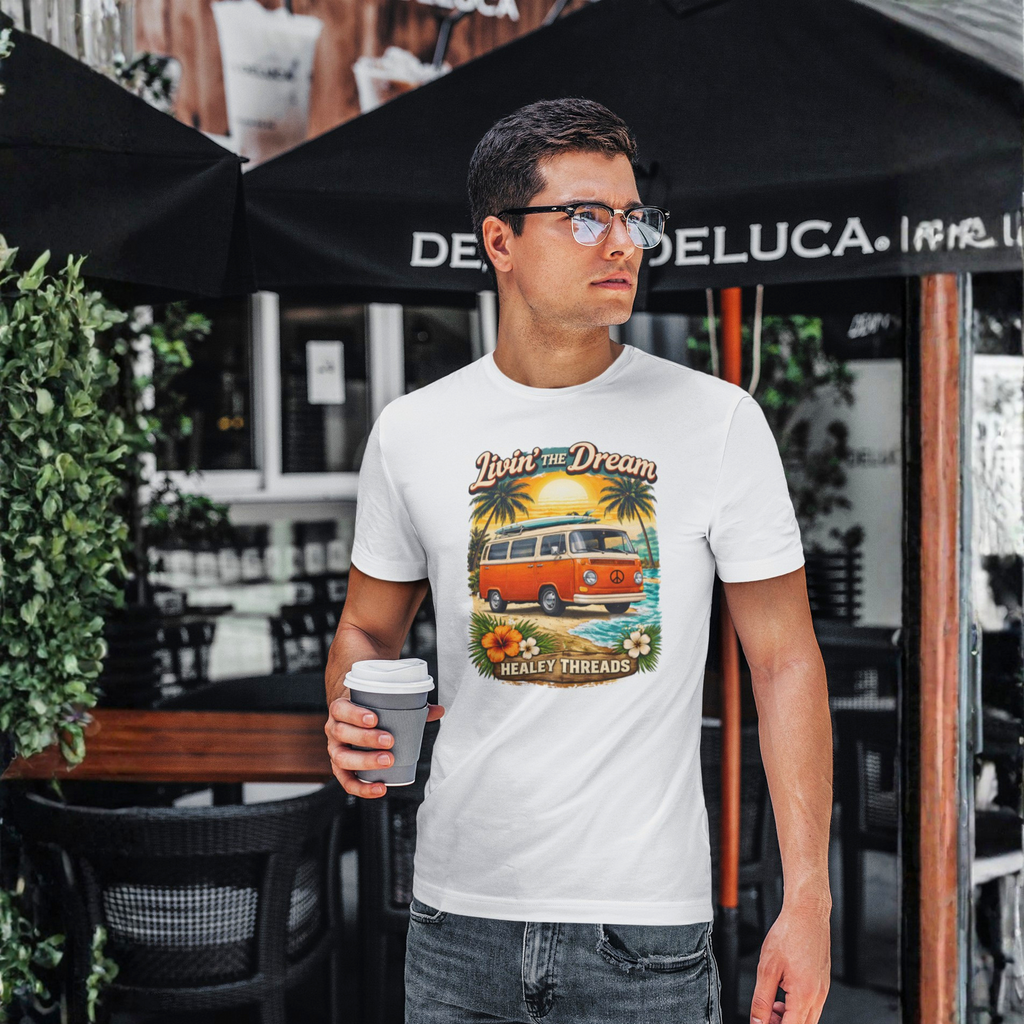Man wearing a t-shirt with a graphic van design, holding a coffee cup, standing outdoors.