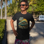 Man wearing a black t-shirt with a graphic Mopar van design and sunglasses, standing outdoors with palm trees in the background.