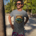Man wearing a sport gray t-shirt with a van graphic and text on a beach