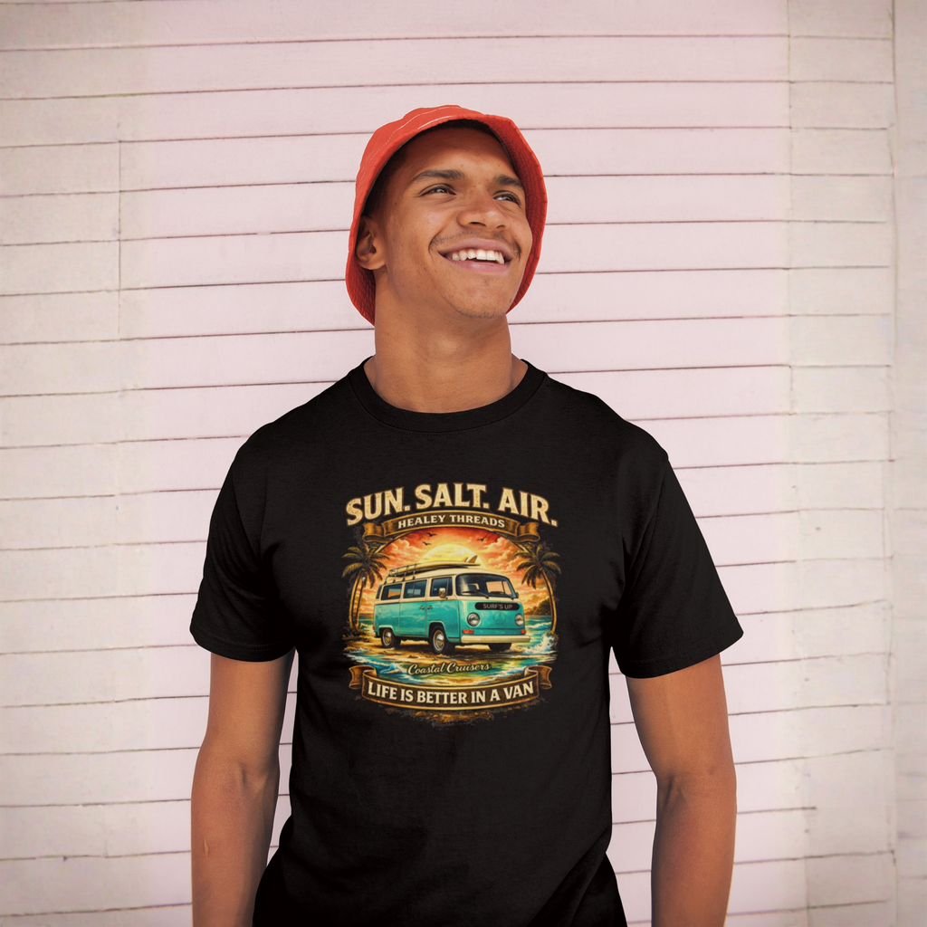 Person wearing a black t-shirt with a graphic van design and text, standing against a light wooden panel background.