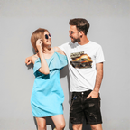 Man and woman standing against a gray background, man wearing a 'American Muscle' t-shirt.