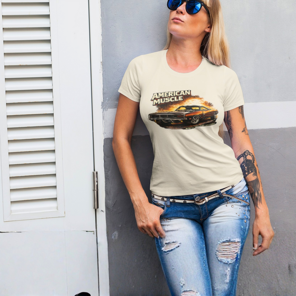 Woman wearing a natural t-shirt with 'American Muscle' graphic design, standing against a gray wall.