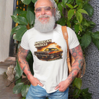 Man wearing a white t-shirt with 'American Muscle' graphic design, standing outdoors with plants in the background.