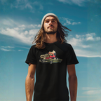 Man wearing a black t-shirt with 'American Muscle' graphic against a blue sky.