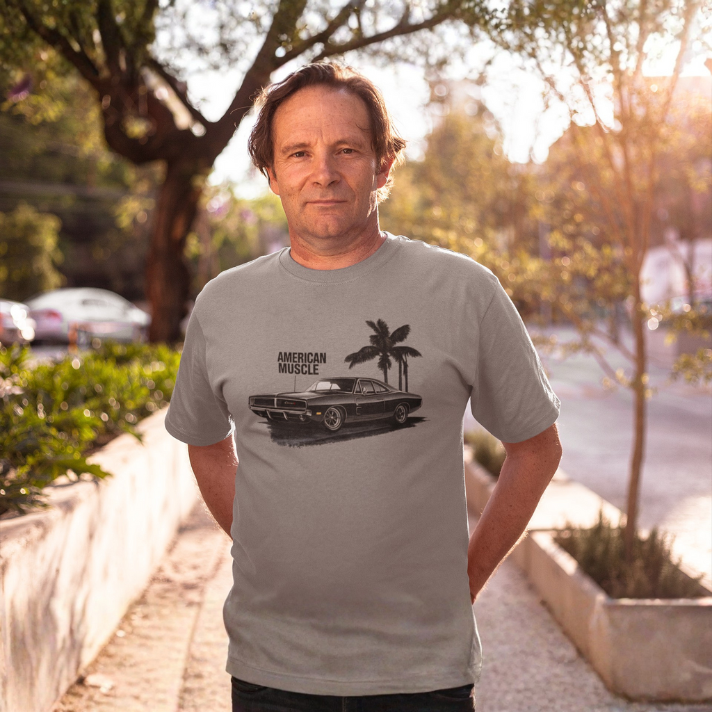 Man wearing a gray t-shirt with a car graphic and 'American Muscle' text, standing outdoors.