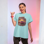 Woman wearing a light blue t-shirt with a graphic design, posing against a gradient background.
