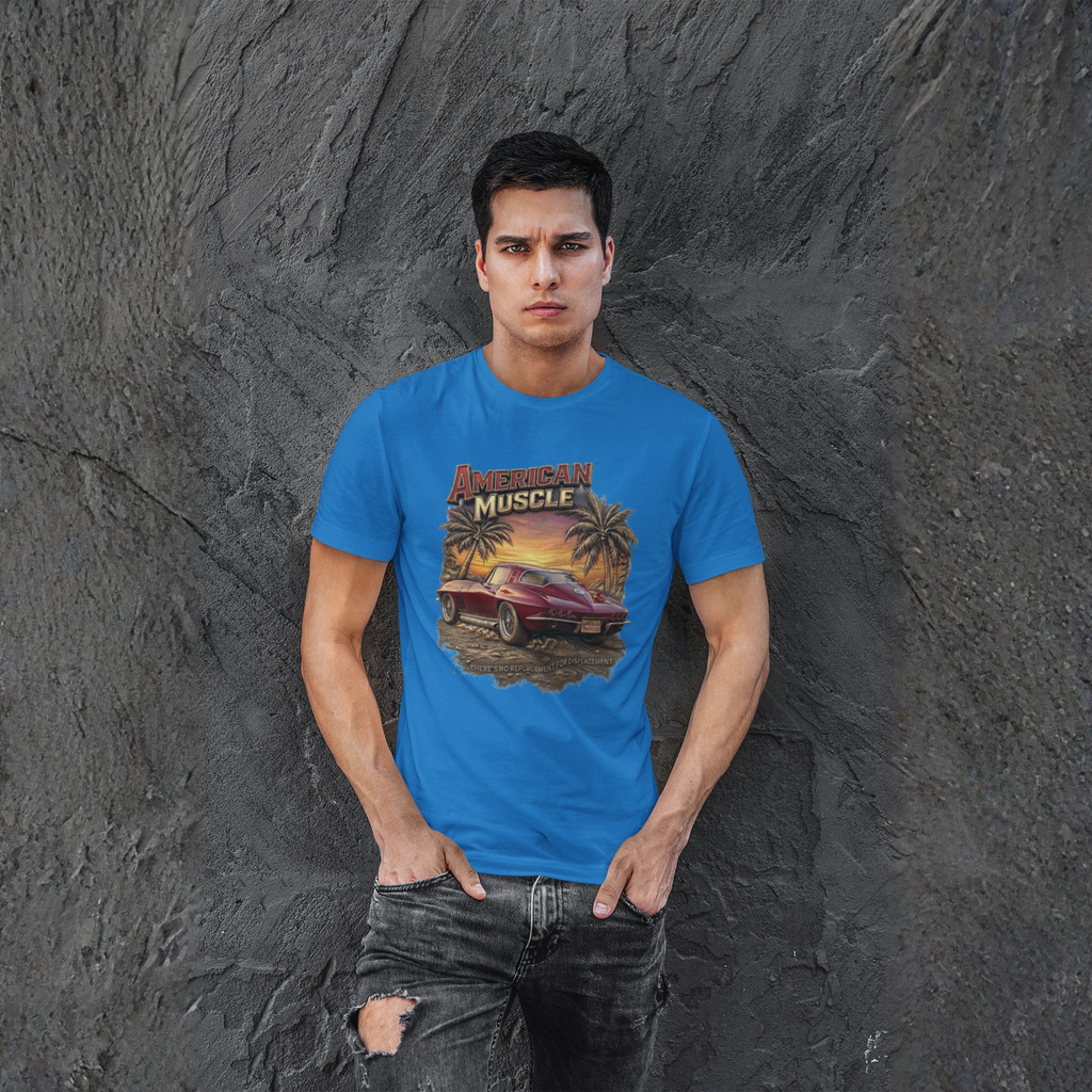 Man wearing a blue t-shirt with a graphic design against a textured gray wall