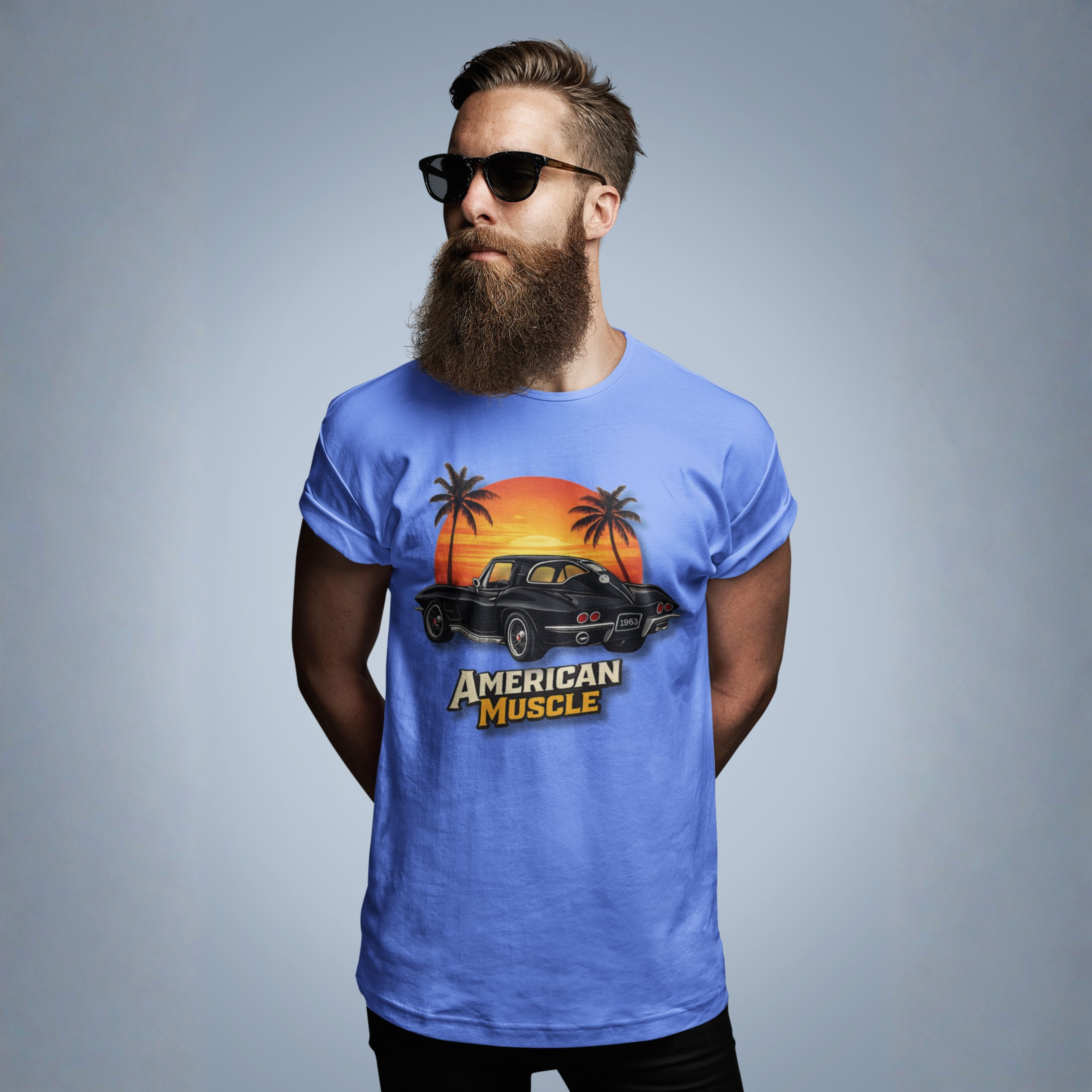 Man wearing a blue t-shirt with 'American Muscle' graphic design on a gray background