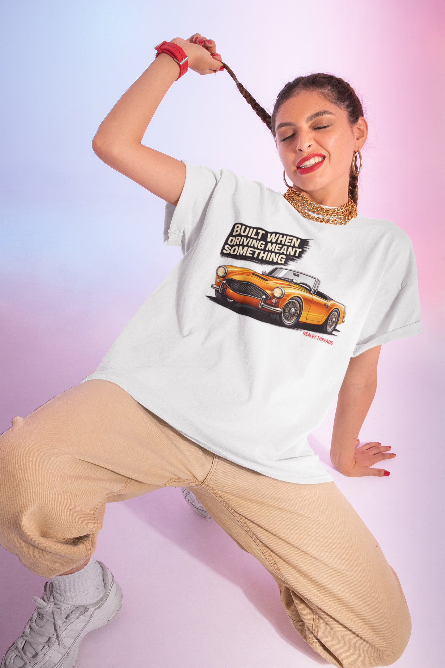 Girl wearing a white t-shirt with a British classic car graphic design on a gradient background