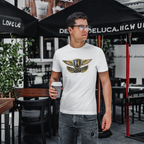 Man wearing a white t-shirt with a Austin Healey logo, holding a coffee cup, standing under black umbrellas.