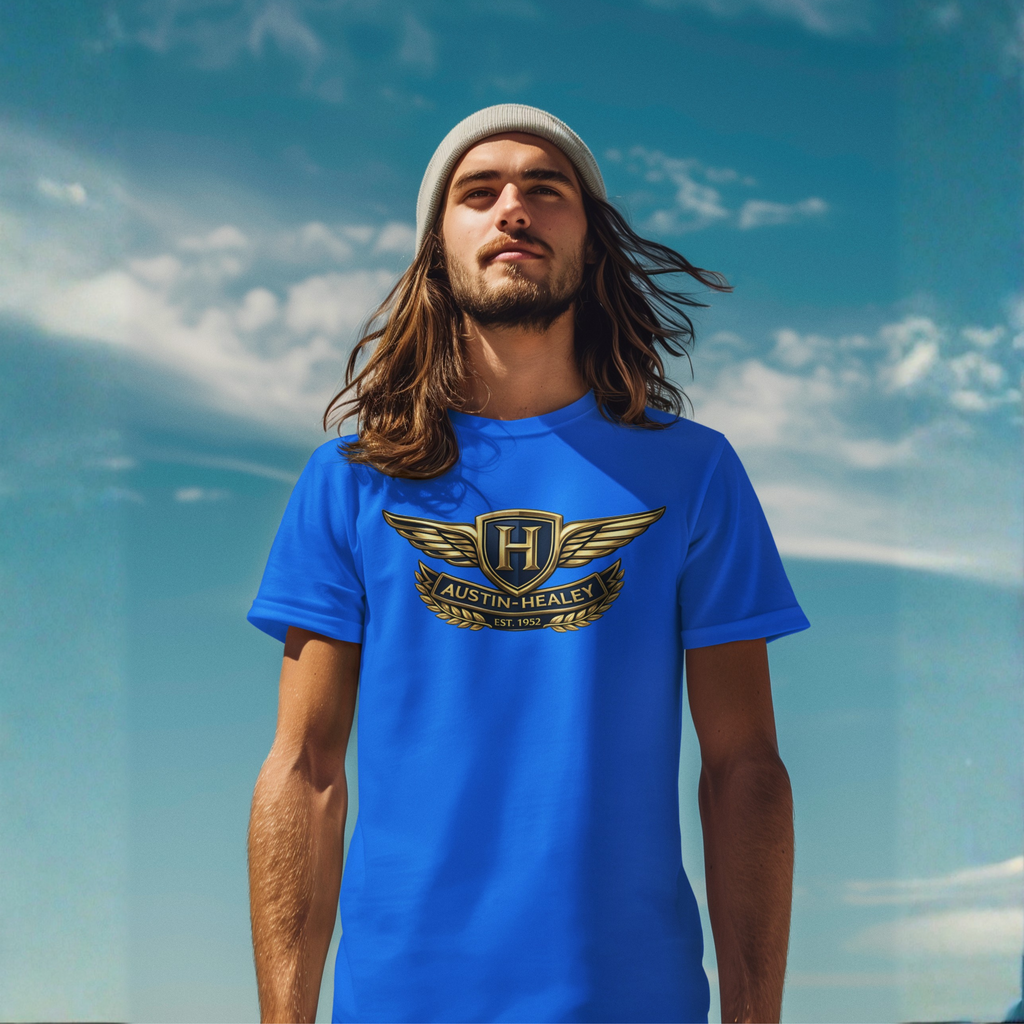 Man wearing a royal blue t-shirt with an Austin-Healey logo against a blue sky.