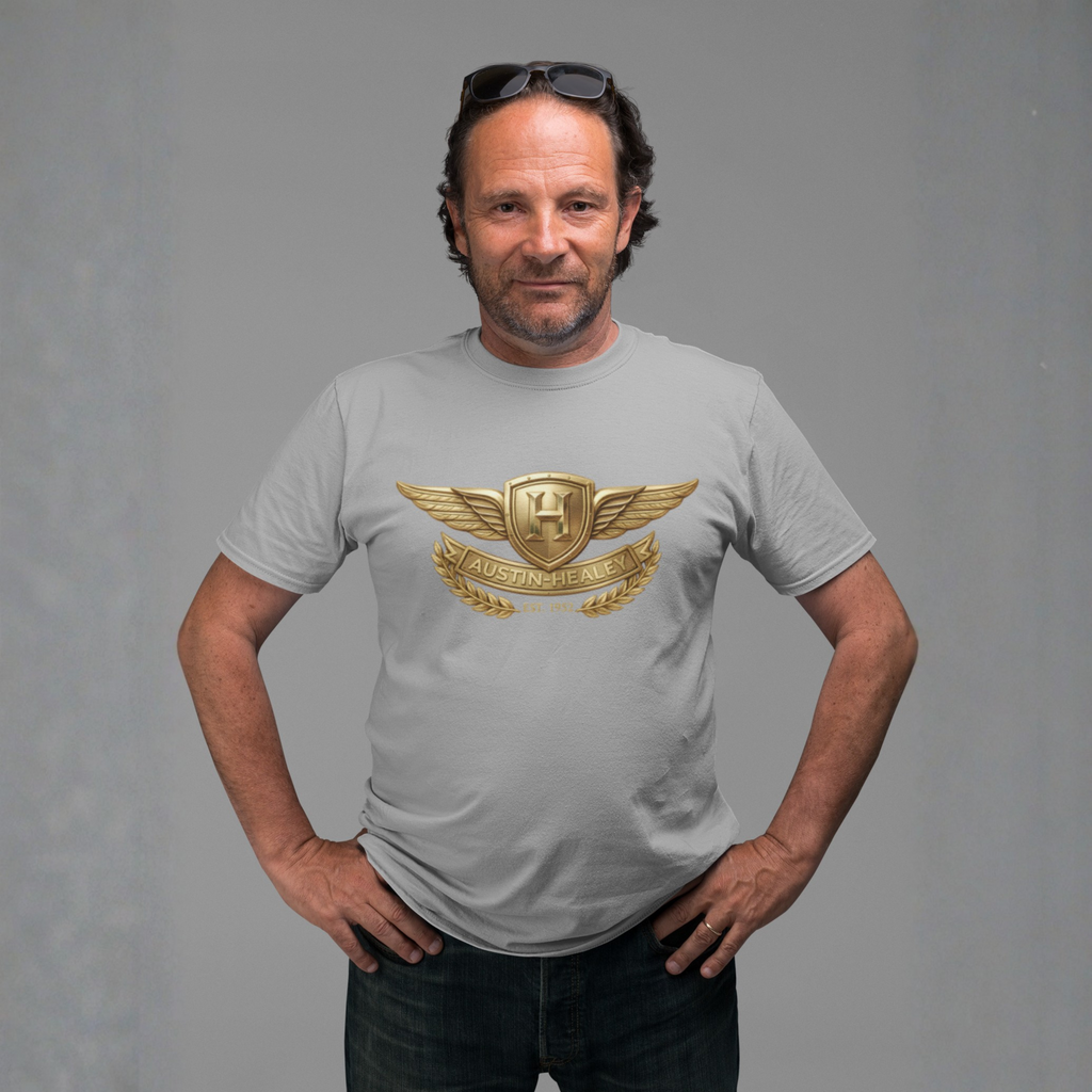 Man wearing a gray t-shirt with a gold Healey design on a gray background