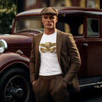 Man in a brown suit and flat cap standing in front of an old car wearing a white tee with a gold Healey logo